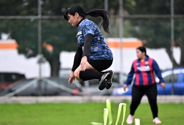 Anita Reyes, a 52-year-old teacher, jumps during a training session within the Women’s Football Comprehensive Training Programme at the Catholic University in Quito on February 4, 2026. The Centre for Knowledge Transfer and Social Innovation at the Catholic University of Quito fosters a safe and inclusive space in which women can participate in the football team, regardless of their age. (Photo by Rodrigo BUENDIA / AFP)