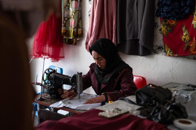 This photograph taken on January 20, 2026 shows Afghan tailoress Rahima Alavi embroidering a scarf at her boutique in Bamiyan. With women banned from most jobs in Afghanistan, an embroidery boutique run by 22-year-old Alavi is a surprising and treasured sight in Bamiyan. Alavi is one of more than five million people who returned to the country since 2023 from neighbouring Iran and Pakistan, which have been pushing back Afghans after decades of hosting them. (Photo by Wakil KOHSAR / AFP) / To go with 'Afghanistan-Women-Migration-Economy', REPORTAGE