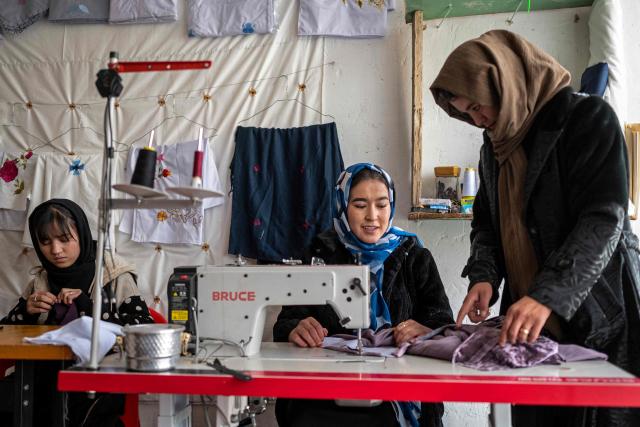 This photograph taken on January 20, 2026 shows Afghan women embroidering scarves and clothes at a boutique in Bamiyan. With women banned from most jobs in Afghanistan, an embroidery boutique run by 22-year-old Rahima Alavi is a surprising and treasured sight in Bamiyan. Alavi is one of more than five million people who returned to the country since 2023 from neighbouring Iran and Pakistan, which have been pushing back Afghans after decades of hosting them. (Photo by Wakil KOHSAR / AFP) / To go with 'Afghanistan-Women-Migration-Economy', REPORTAGE