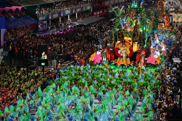 Revellers of the Paraiso do Tuiuti samba school perform during the closing night of the Rio Carnival at the Marques de Sapucai Sambadrome in Rio de Janeiro, Brazil on February 17, 2026. (Photo by Pablo PORCIUNCULA / AFP)