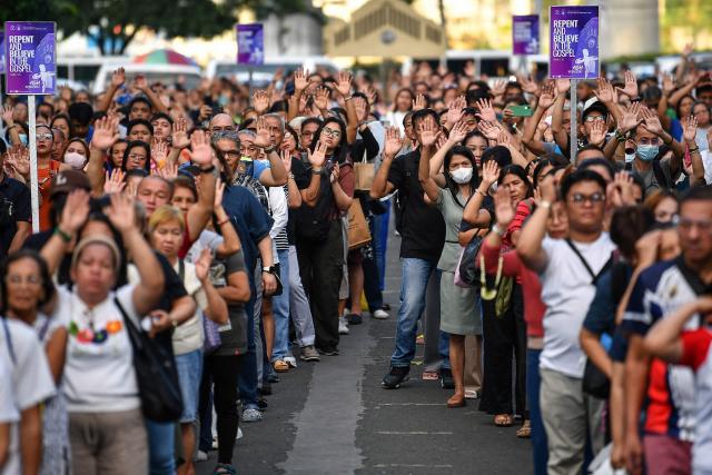 Catholic devotees pray during mass on Ash Wednesday at a church ground in Manila on February 18, 2026. (Photo by Ted ALJIBE / AFP)