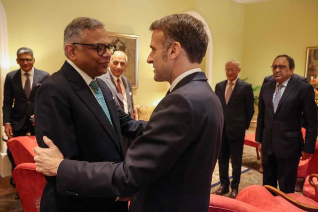 France's President Emmanuel Macron (R) speaks with Chairman of the Board at Tata Sons Natarajan Chandrasekaran during a meeting with investors in Mumbai on February 18, 2026. (Photo by Ludovic MARIN / AFP)