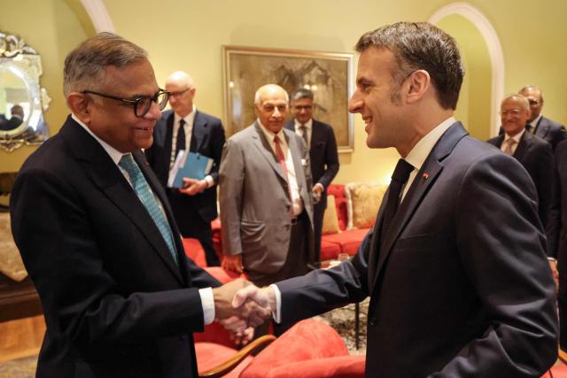 France's President Emmanuel Macron (R) speaks with Chairman of the Board at Tata Sons Natarajan Chandrasekaran during a meeting with investors in Mumbai on February 18, 2026. (Photo by Ludovic MARIN / AFP)