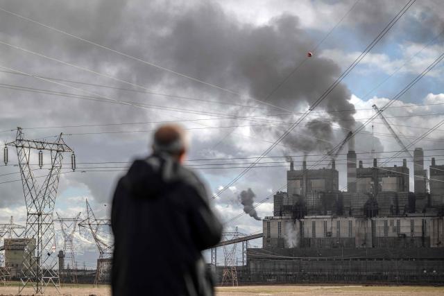 A man looks at clouds of water vapor rising from the Afsin-Elbistan coal-based power plant in Elbistan on February 11, 2026. The power plant has operated since 1984 and is one of Turkey's largest thermal facilities, with eight units generating 2,795 megawatts. It relies on lignite from the Afsin?Elbistan basin, which holds around 40 percent of the country's known reserves. Environmental groups say they are alarmed by government plans to expand Plant A with two new units as part of efforts to reduce reliance on energy imports. (Photo by Ozan KOSE / AFP)
