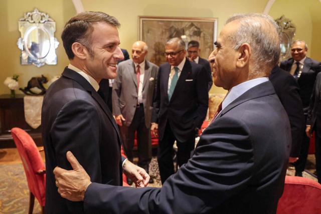 France's President Emmanuel Macron (L) speaks with chairman of Bharti Enterprises Sunil Bharti Mittal during a meeting with investors in Mumbai on February 18, 2026. (Photo by Ludovic MARIN / AFP)