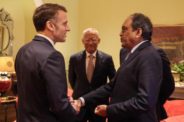 France's President Emmanuel Macron (L) speaks with Chairman and Managing Director of Larsen & Toubro Sekharipuram Narayanan Subrahmanyan during a meeting with investors in Mumbai on February 18, 2026. (Photo by Ludovic MARIN / AFP)