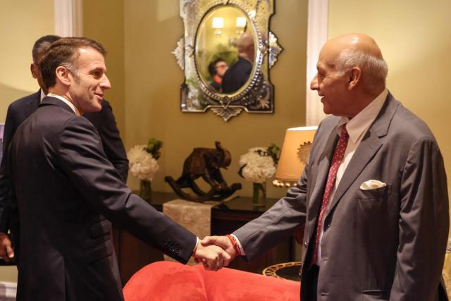 France's President Emmanuel Macron (L) speaks with chairman and co-founder of Samvardhana Motherson Group Vivek Sehgal during a meeting with investors in Mumbai on February 18, 2026. (Photo by Ludovic MARIN / AFP)