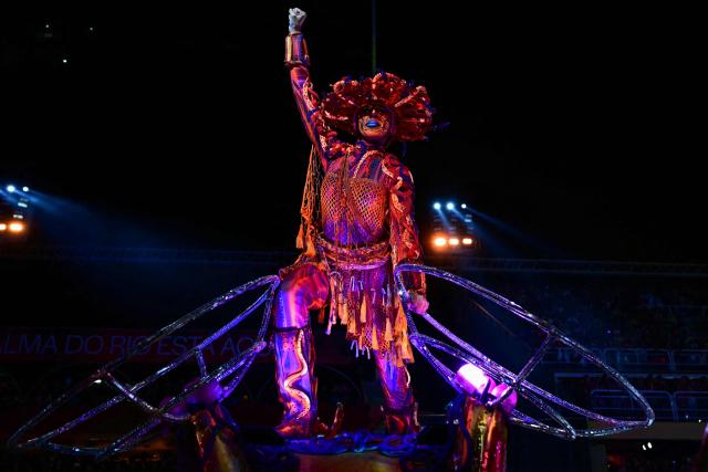 A reveller of the Academicos do Grande Rio samba school performs on a float during the closing night of the Rio Carnival at the Marques de Sapucai Sambadrome in Rio de Janeiro, Brazil, early on February 18, 2026. (Photo by Pablo PORCIUNCULA / AFP)