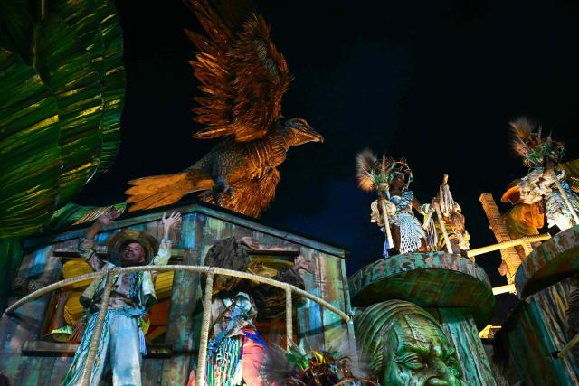 Revellers of the Academicos do Grande Rio samba school perform on a float during the closing night of the Rio Carnival at the Marques de Sapucai Sambadrome in Rio de Janeiro, Brazil, early on February 18, 2026. (Photo by Pablo PORCIUNCULA / AFP)