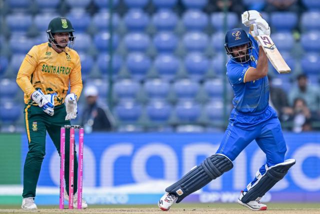 UAE's Aryansh Sharma (R) plays a shot as South Africa's wicketkeeper Quinton de Kock watches during the 2026 ICC Men's T20 Cricket World Cup group stage match between South Africa and United Arab Emirates at the Arun Jaitley Stadium in New Delhi on February 18, 2026. (Photo by Arun SANKAR / AFP)