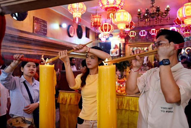 People burn incense and pray at a temple on the second day of the Lunar New Year of the Horse in Phnom Penh on February 18, 2026. (Photo by TANG CHHIN Sothy / AFP)