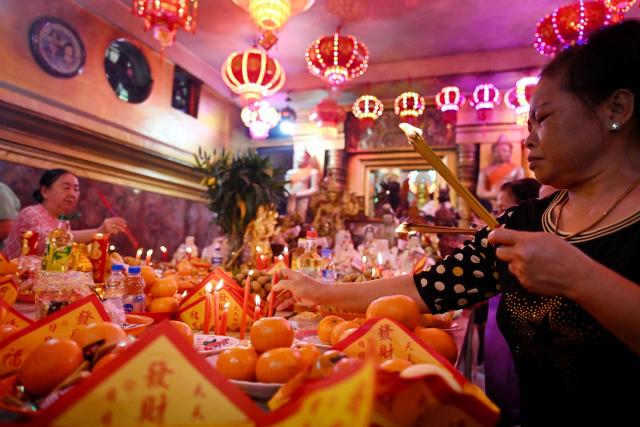 People burn incense and pray at a temple on the second day of the Lunar New Year of the Horse in Phnom Penh on February 18, 2026. (Photo by TANG CHHIN Sothy / AFP)