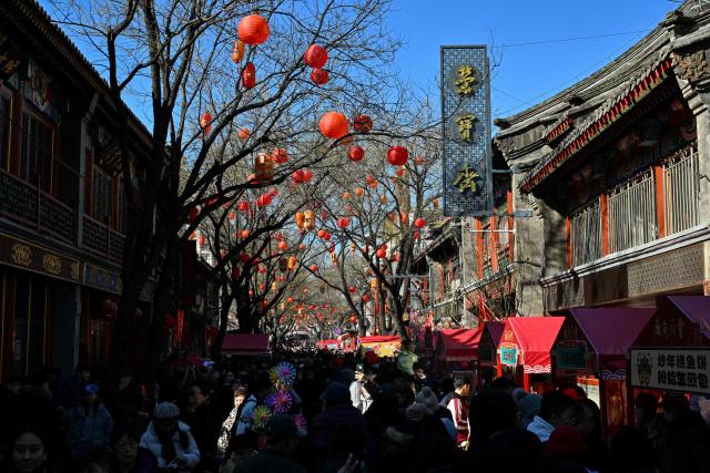 People visit a temple fair on the second day of the Lunar New Year of the Horse in Beijing on February 18, 2026. (Photo by Adek BERRY / AFP)