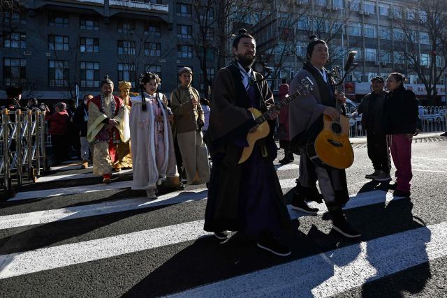 Performers participate in a parade as people visit a temple fair on the second day of the Lunar New Year of the Horse in Beijing on February 18, 2026. (Photo by Adek BERRY / AFP)