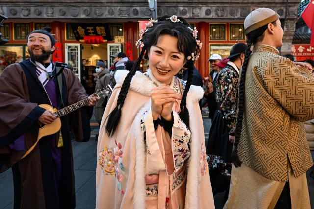 Performers participate in a parade as people visit a temple fair on the second day of the Lunar New Year of the Horse in Beijing on February 18, 2026. (Photo by Adek BERRY / AFP)