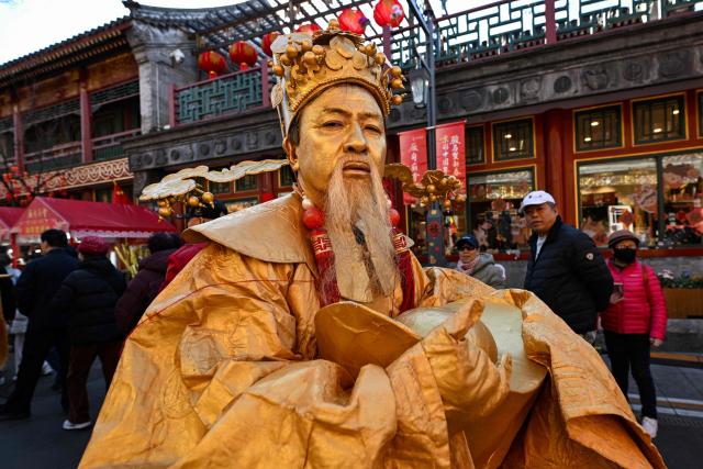 A performer participates in a parade as people visit a temple fair on the second day of the Lunar New Year of the Horse in Beijing on February 18, 2026. (Photo by Adek BERRY / AFP)