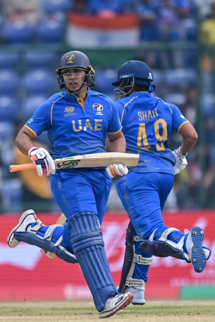UAE's Alishan Sharafu (L) and Haider Shah run between the wickets during the 2026 ICC Men's T20 Cricket World Cup group stage match between South Africa and United Arab Emirates at the Arun Jaitley Stadium in New Delhi on February 18, 2026. (Photo by Arun SANKAR / AFP)