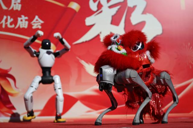 Robots perform at a fair in a park on the second day of the Lunar New Year of the Horse in Beijing on February 18, 2026. (Photo by Pedro PARDO / AFP)
