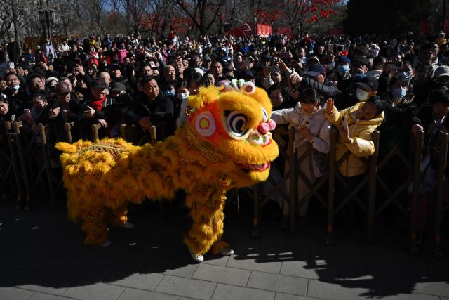 Lion dancers perform at a fair in a park on the second day of the Lunar New Year of the Horse in Beijing on February 18, 2026. (Photo by Pedro PARDO / AFP)