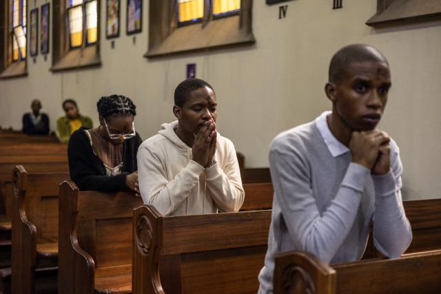 Catholics pray during the Ash Wednesday Mass at the Holy Trinity Catholic Church in Braamfontein, Johannesburg, on February 18, 2026. (Photo by ILARIA FINIZIO / AFP)