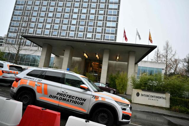 A Swiss diplomatic protection vehicle drives past the hotel where is taking place a second day of US-mediated talks with Russia and Ukraine seeking to find an end to the four-year war, in Geneva on February 18, 2026.  (Photo by Harold CUNNINGHAM / AFP)