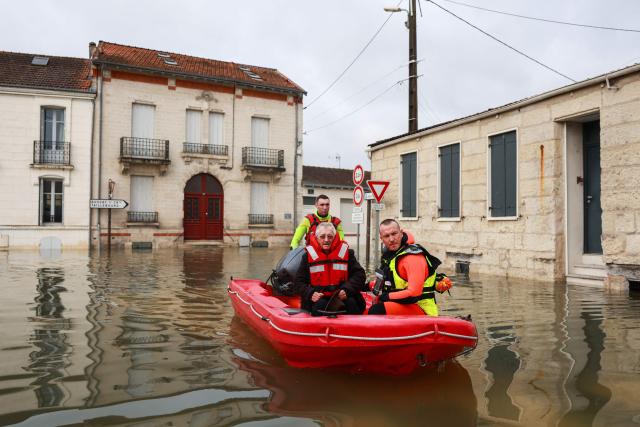 Rescuers navigate on a bark on a flooded street following the flood of the Charente river in Saintes, western France, on February 18, 2026. Charente-Maritime, Gironde, Lot-et-Garonne and Maine-et-Loire remain on red alert for flooding until at least February 19, 2026, Vigicrues announced on February 18, 2026, indicating that nine departments are on orange alert for flooding or rain-related flooding as Storm Pedro approaches. (Photo by ROMAIN PERROCHEAU / AFP)
