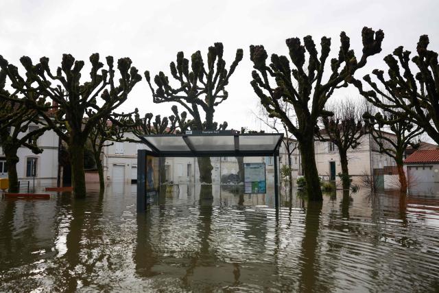 This photograph shows a a bus shelter flooded following heavy rain in the city centre of Saintes, western France, on February 18, 2026. Charente-Maritime, Gironde, Lot-et-Garonne and Maine-et-Loire remain on red alert for flooding until at least February 19, 2026, Vigicrues announced on February 18, 2026, indicating that nine departments are on orange alert for flooding or rain-related flooding as Storm Pedro approaches. (Photo by ROMAIN PERROCHEAU / AFP)