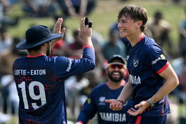 Namibia's Jack Brassell (R) celebrates with teammates after taking the wicket of Pakistan's Saim Ayub during the 2026 ICC Men's T20 Cricket World Cup group stage match between Pakistan and Namibia at the Sinhalese Sports Club (SSC) Ground in Colombo on February 18, 2026. (Photo by Ishara S. KODIKARA / AFP)