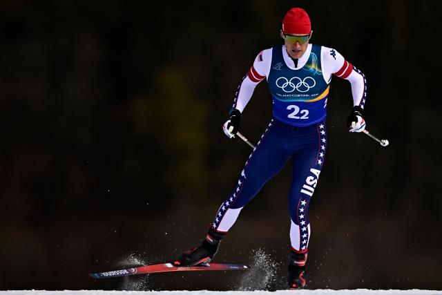 USA's Gus Schumacher competes during the men's team cross country free sprint qualification event of the Milano Cortina 2026 Winter Olympic Games at Tesero Cross-Country Skiing Stadium in Lago di Tesero (Val di Fiemme), on February 18, 2026. (Photo by Tobias SCHWARZ / AFP)
