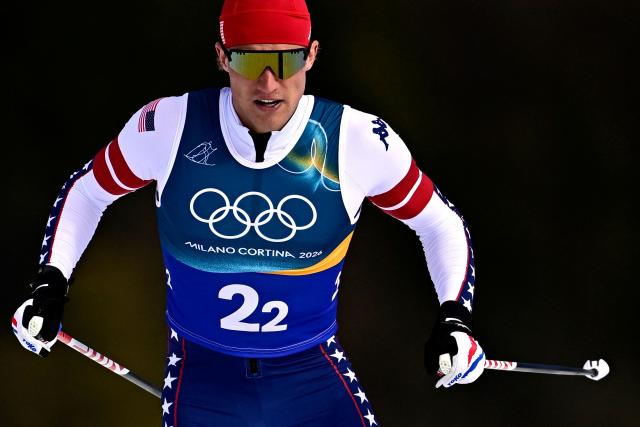 USA's Gus Schumacher competes during the men's team cross country free sprint qualification event of the Milano Cortina 2026 Winter Olympic Games at Tesero Cross-Country Skiing Stadium in Lago di Tesero (Val di Fiemme), on February 18, 2026. (Photo by Tobias SCHWARZ / AFP)