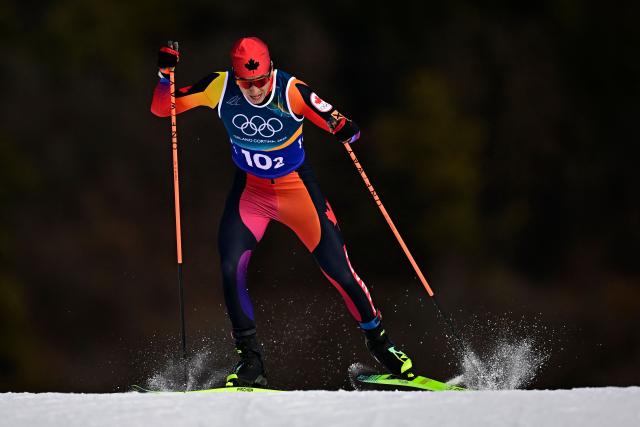 Canada's Xavier McKeever competes during the men's team cross country free sprint qualification event of the Milano Cortina 2026 Winter Olympic Games at Tesero Cross-Country Skiing Stadium in Lago di Tesero (Val di Fiemme), on February 18, 2026. (Photo by Tobias SCHWARZ / AFP)