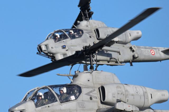 Soldiers in helicopters take part in NATO's STEADFAST DART 26 exercise in Putlos, Germany, on February 18, 2026. (Photo by Fabian Bimmer / POOL / AFP)