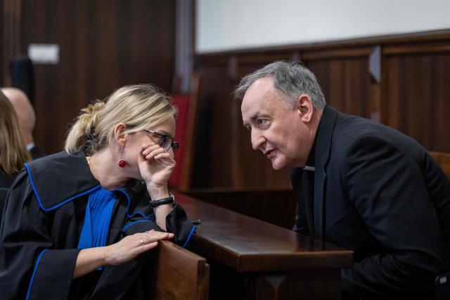 Andrzej Jez (R), catholic bishop of the Diocese of Tarnów in Poland, chats with his lawyer Monika Brzozowska-Pasieka (R) in a courtroom of the district court in Tarnów, Poland, where he is accused of allegedly covering up paedophilia by priests in his diocese, on February 18, 2026. The Bishop of Tarnow Andrzej Jez is the first member of the hierarchy to face criminal charges for failing to inform authorities of abuse by clergy. (Photo by Wojtek RADWANSKI / AFP)