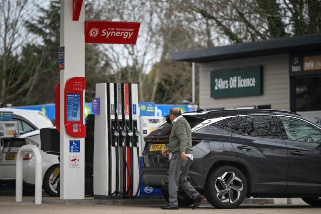 A man stops to fill up his car at a petrol station in the Wandsworth area of southwest London on February 18, 2026. Britain's annual inflation rate eased in line with expectations in January, official data showed on February 18, bolstering chances that the Bank of England will cut its benchmark interest rate next month. (Photo by JUSTIN TALLIS / AFP)