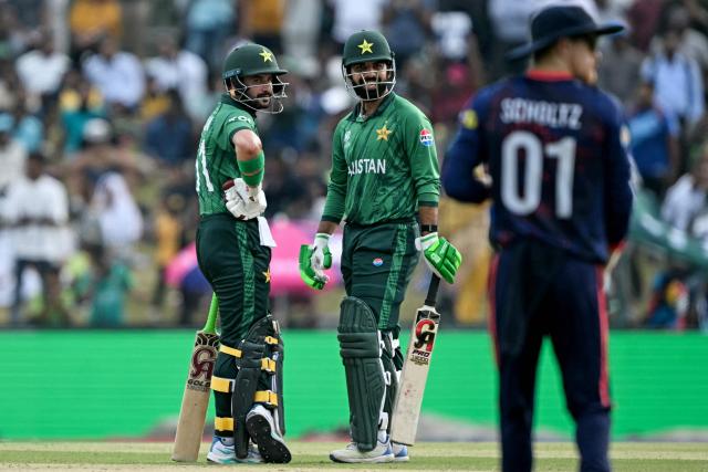 Pakistan's Sahibzada Farhan (L) and Shadab Khan look on during the 2026 ICC Men's T20 Cricket World Cup group stage match between Pakistan and Namibia at the Sinhalese Sports Club (SSC) Ground in Colombo on February 18, 2026. (Photo by Ishara S. KODIKARA / AFP)