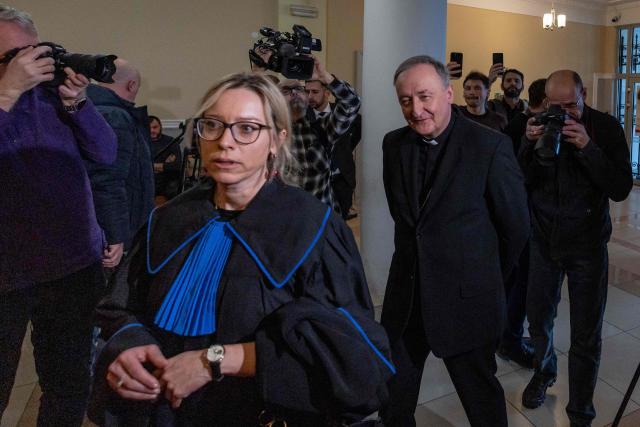 Andrzej Jez (C-R), catholic bishop of the Diocese of Tarnów in Poland, arrives at the district court in Tarnów, where he is accused of allegedly covering up paedophilia by priests in his diocese, on February 18, 2026. The Bishop of Tarnow Andrzej Jez is the first member of the hierarchy to face criminal charges for failing to inform authorities of abuse by clergy. (Photo by Wojtek RADWANSKI / AFP)
