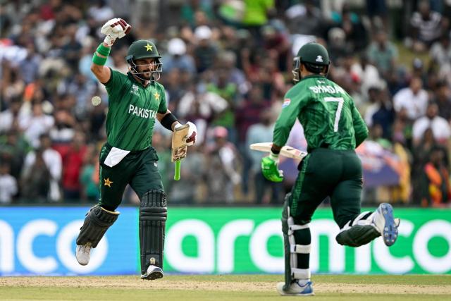 Pakistan's Sahibzada Farhan (L) celebrates with Shadab Khan after scoring a century (100 runs) during the 2026 ICC Men's T20 Cricket World Cup group stage match between Pakistan and Namibia at the Sinhalese Sports Club (SSC) Ground in Colombo on February 18, 2026. (Photo by Ishara S. KODIKARA / AFP)