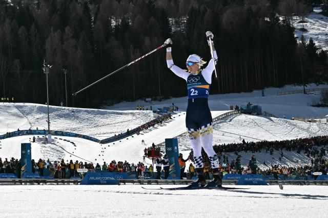 Sweden's Maja Dahlqvist celebrates after crossing the finish line for Sweden to win gold during the women's team cross country free sprint final event of the Milano Cortina 2026 Winter Olympic Games at Tesero Cross-Country Skiing Stadium in Lago di Tesero (Val di Fiemme), on February 18, 2026. (Photo by Javier SORIANO / AFP)