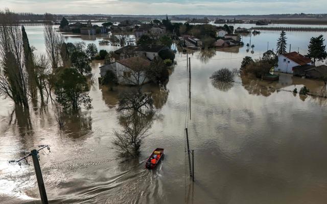 A general view shows floodwater surrounding houses in Jusix, in the Lot-and-Garonne department of southwestern France on February 18, 2026. (Photo by Ed JONES / AFP)