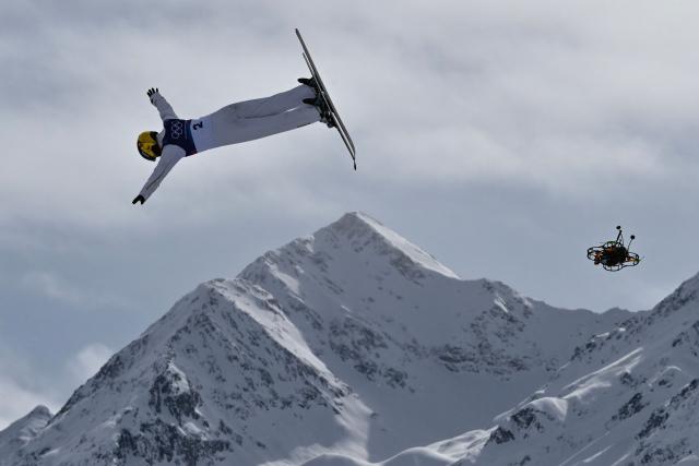 A broadcast drone hovers as China's Kong Fanyu competes in the freestyle skiing women's aerials final 1 during the Milano Cortina 2026 Winter Olympic Games at Livigno Aerials & Moguls Park, in Livigno (Valtellina), on February 18, 2026. (Photo by Jeff PACHOUD / AFP)