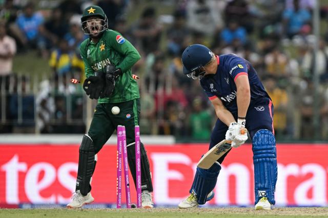 Namibia's Ruben Trumpelmann (R) is clean bowled by Pakistan's Usman Tariq as wicketkeeper Usman Khan (L) reacts during the 2026 ICC Men's T20 Cricket World Cup group stage match between Pakistan and Namibia at the Sinhalese Sports Club (SSC) Ground in Colombo on February 18, 2026. (Photo by Ishara S. KODIKARA / AFP)