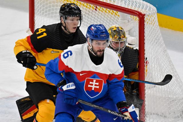 (From L) Germany's #41 Jonas Muller, Slovakia's #06 Lukas Cingel and Germany's #30 Philipp Grubauer vie for the puck during the men's play-off quarter-final ice hockey match between Slovakia and Germany at the Milano Santagiulia Ice Hockey Arena during the Milano Cortina 2026 Winter Olympic Games in Milan, on February 18, 2026. (Photo by Alexander NEMENOV / AFP)