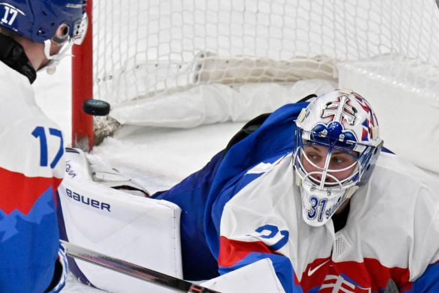 Slovakia's #31 Samuel Hlavaj (R) and Slovakia's #17 Simon Nemec fail to save the puck as Germany's #95 Frederik Tiffels (not pictured) scores his team's second goal during the men's play-off quarter-final ice hockey match between Slovakia and Germany at the Milano Santagiulia Ice Hockey Arena during the Milano Cortina 2026 Winter Olympic Games in Milan, on February 18, 2026. (Photo by Alexander NEMENOV / AFP)