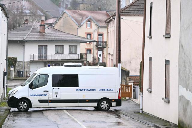A vehicle belonging to the French gendarmerie's criminal identification unit is parked during a police search in the house (R) where the bodies of two infants have been discovered in a freezer in Ailleviller-et-Lyaumont, eastern France on February 18, 2026. The mother of the two babies found frozen in a village in Haute-Saone was indicted on February 13, 2026 for the murder of minors and placed in pre-trial detention, Besançon public prosecutor Cédric Logelin told AFP on February 14, 2026. (Photo by SEBASTIEN BOZON / AFP)