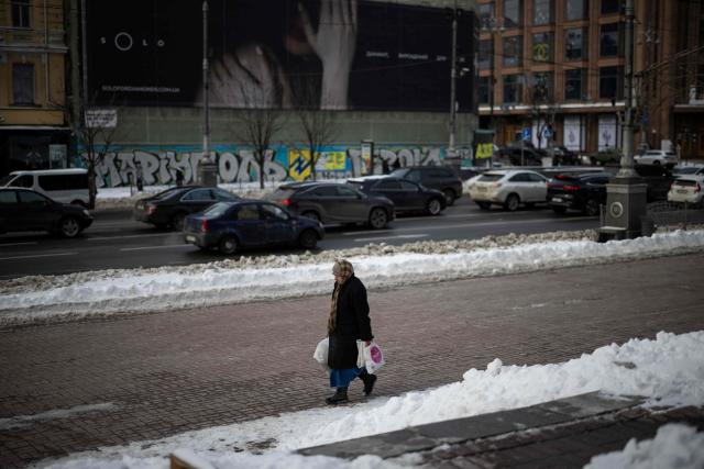 A person carries shopping bags in central in Kyiv on February 18, 2026, amid the Russian invasion of Ukraine. (Photo by HENRY NICHOLLS / AFP)