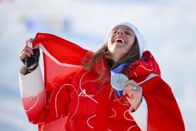 Switzerland's silver medallist Camille Rast celebrates during the podium ceremony of the women's slalom event during the Milano Cortina 2026 Winter Olympic Games at the Tofane Alpine Skiing Centre in Cortina d’Ampezzo on February 18, 2026. (Photo by Marco BERTORELLO / AFP)