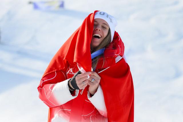 Switzerland's silver medallist Camille Rast celebrates during the podium ceremony of the women's slalom event during the Milano Cortina 2026 Winter Olympic Games at the Tofane Alpine Skiing Centre in Cortina d’Ampezzo on February 18, 2026. (Photo by Marco BERTORELLO / AFP)