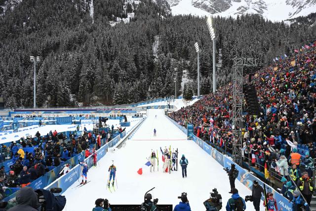 France's Camille Bened, Lou Jeanmonnot, Oceane Michelon and Julia Simon celebrate after winning gold in the women's biathlon 4x6km relay event during the Milano Cortina 2026 Winter Olympic Games at the Anterselva Biathlon Arena (Sudtirol Arena) in Anterselva (Val Pusteria) on February 18, 2026. (Photo by François-Xavier MARIT / AFP)