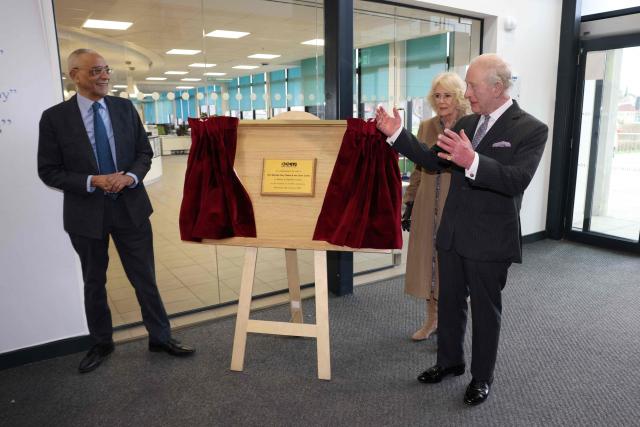 Britain's King Charles III (R) and Queen Camilla commemorate a plaque at Barking and Dagenham College in Rush Green, east London on February 18, 2026, during a visit to meet students in a range of workshops to hear about learning opportunities. (Photo by Ian Vogler / POOL / AFP)