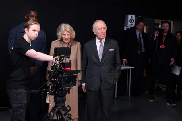 Britain's King Charles III (C) and Queen Camilla (3rd L) pay a visit to the film and TV studio at Barking and Dagenham College alongside British actor Idris Elba (behind L), in Rush Green, east London on February 18, 2026, to meet students in a range of workshops to hear about learning opportunities. (Photo by Ian Vogler / POOL / AFP)